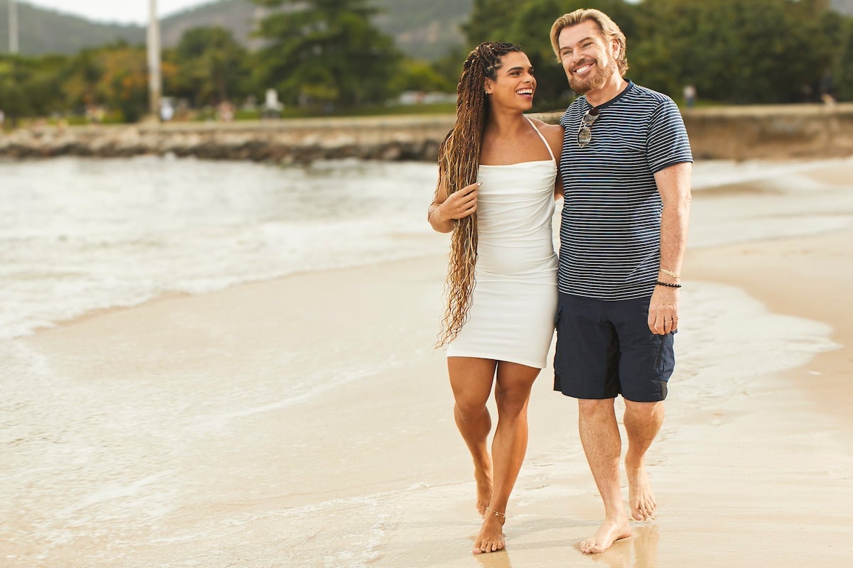 Alliya and Shawn walk on the beach in Brazil