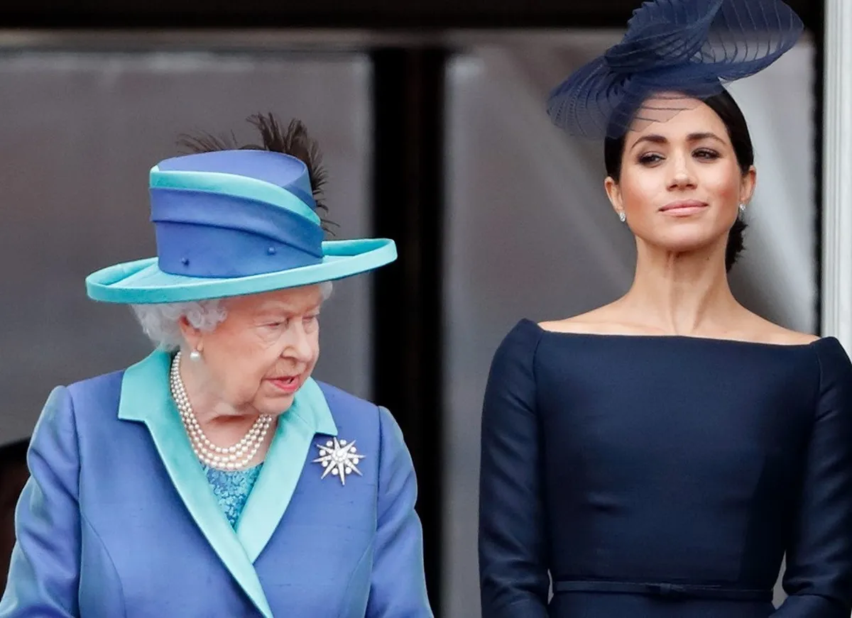 Queen Elizabeth II and Meghan Markle watching a flyover on the balcony of Buckingham Palace