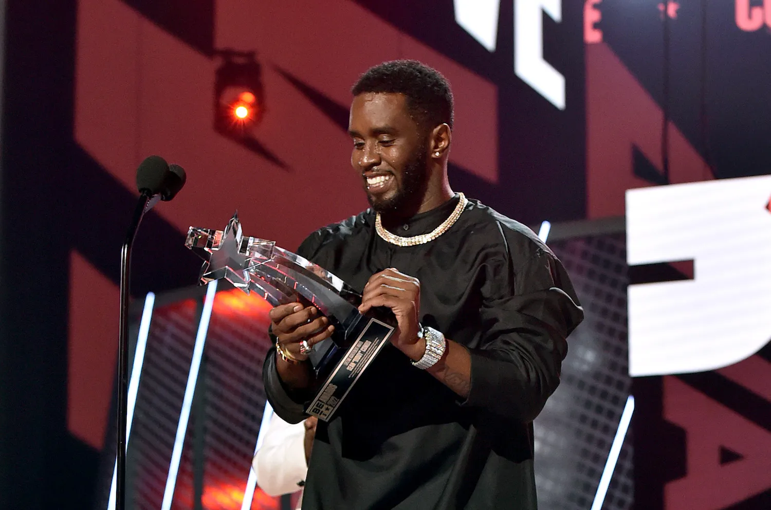 Sean 'Diddy' Combs smiling and accepting an award on stage in 2022