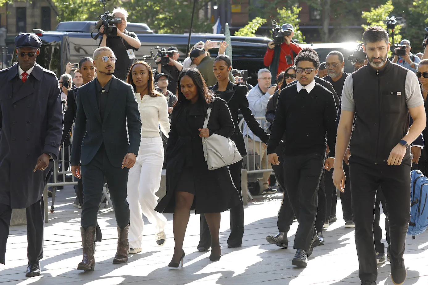 Sean 'Diddy' Combs' kids, Quincy Brown, Chance Combs, D'Lila Star Combs, and Justin Combs arrive for the continuation of the jury selection phase of the trial at the Southern District Manhattan Federal court on May 12, 2025. They are dressed formally and walking in a crowd outside.