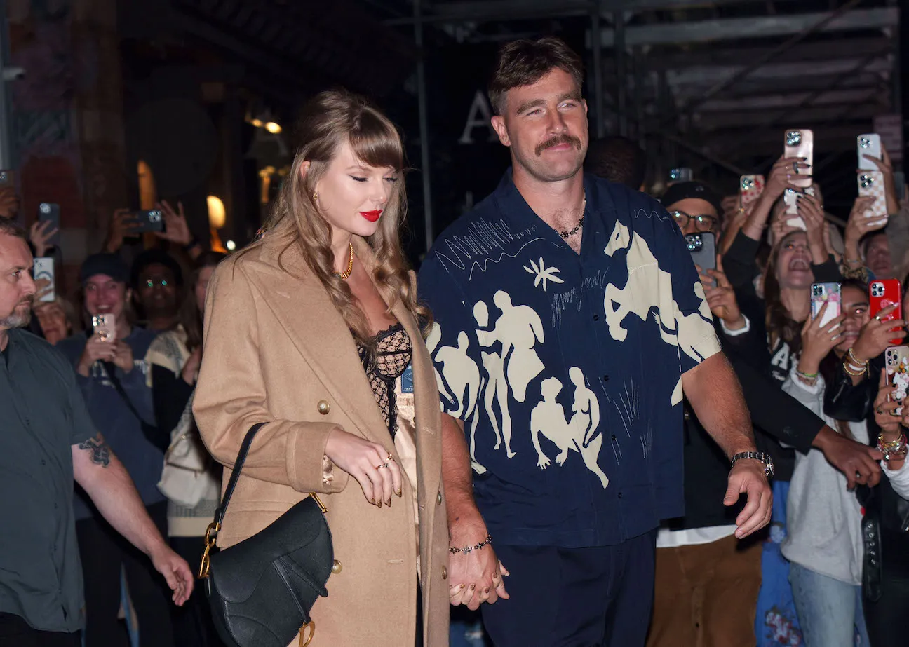 Taylor Swift and Travis Kelce walking hand in hand in New York City
