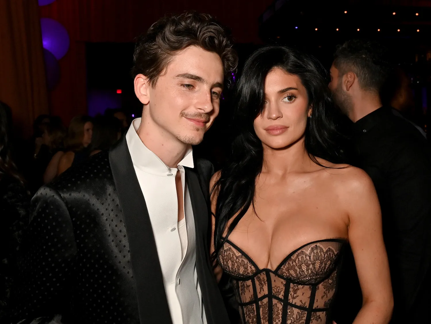 Timothée Chalamet and Kylie Jenner standing side by side in 2025 at the Vanity Fair Oscar Party. They are dressed in black tie.