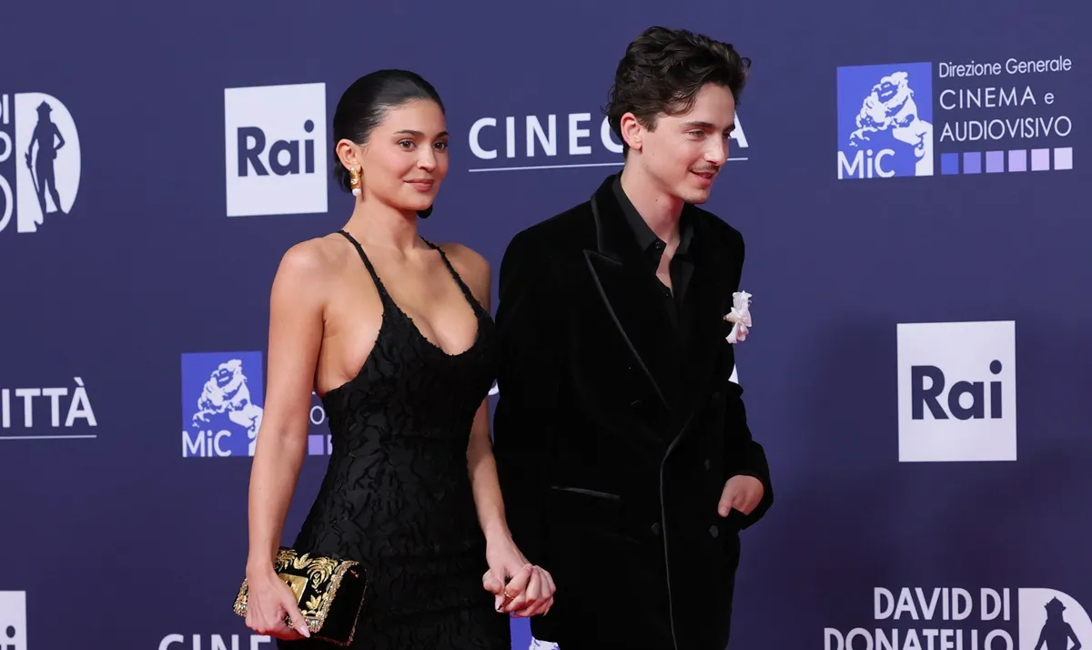 Timothée Chalamet and Kylie Jenner attend the red carpet during the 70th David Di Donatello in Rome. They are walking hand in hand and both dressed in black.