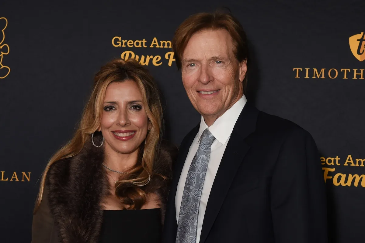Michelle Wolf and Jack Wagner pose for a photo at an event