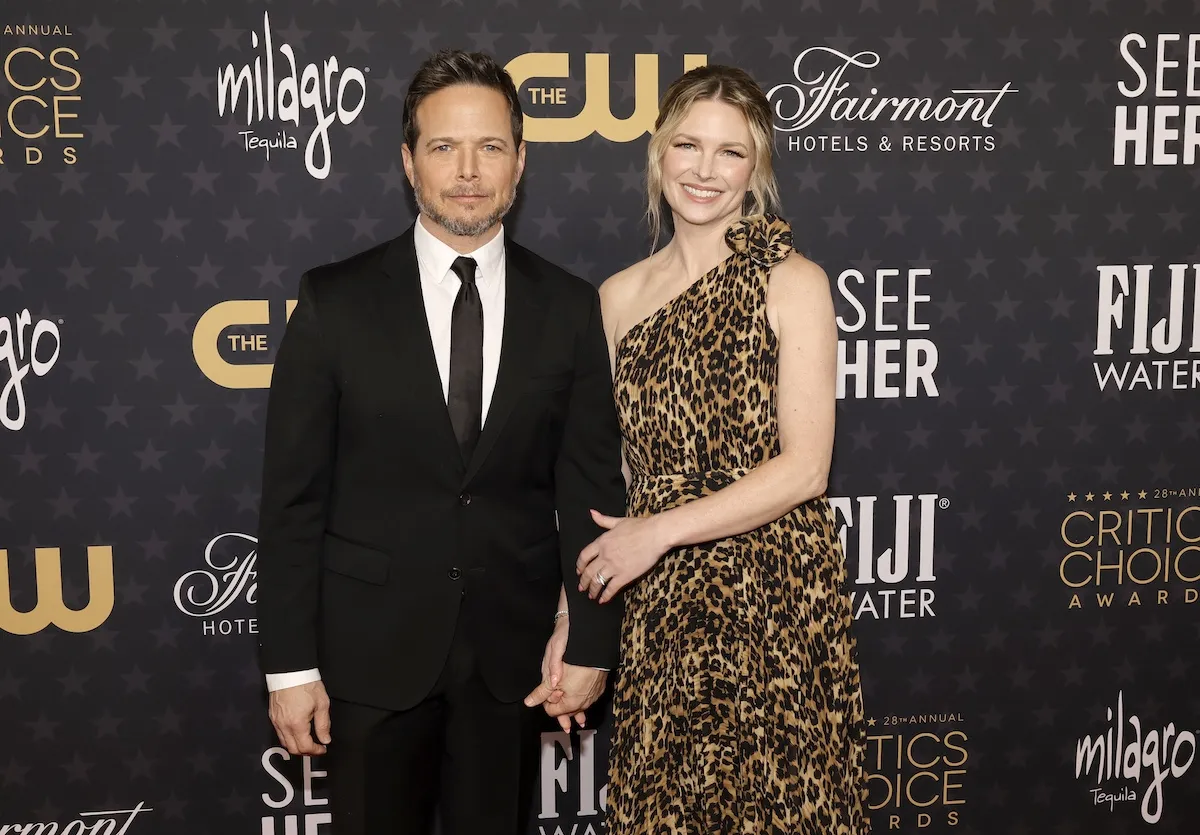 Scott Wolf, in a suit, with his wife Kelley Wolf, in an animal-print dress, in 2023